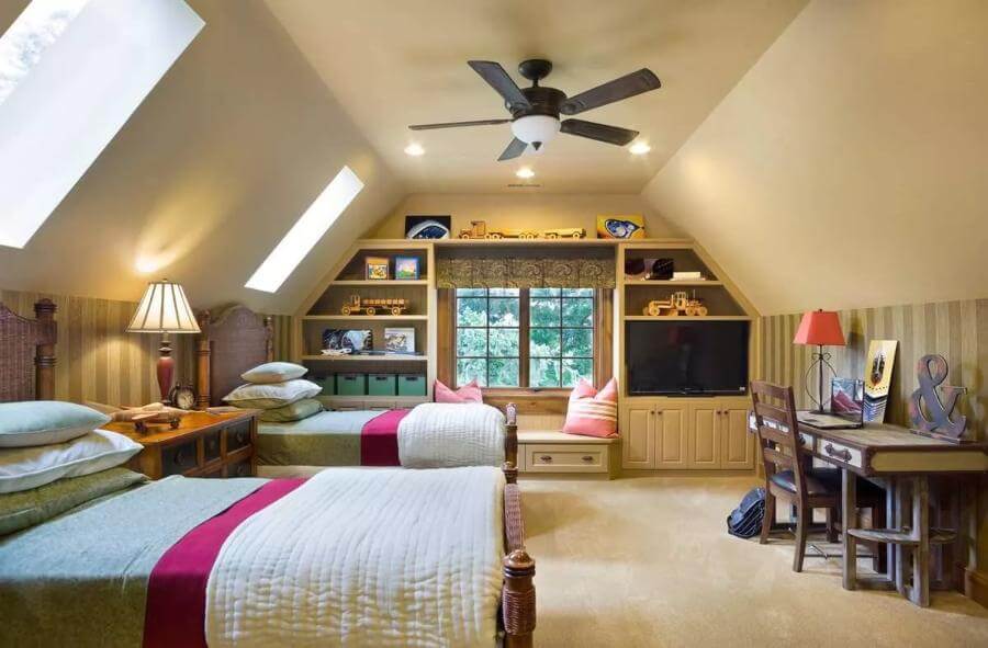 Bedroom containing two beds and a window seat under a coved ceiling.