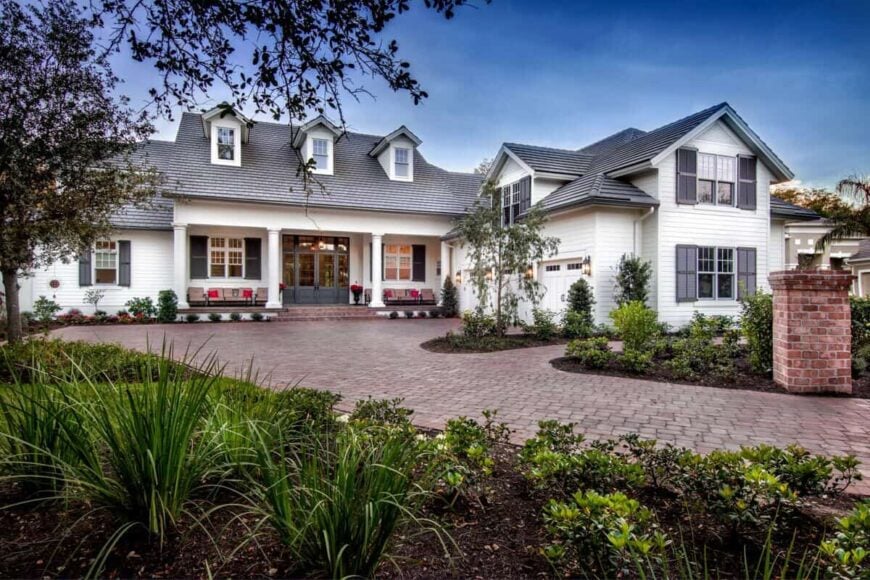 Front exterior view showcasing a courtyard entry garage and a spacious front porch