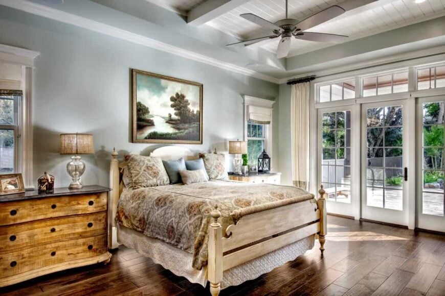 Primary bedroom featuring wooden furniture and outdoor access through a large door.