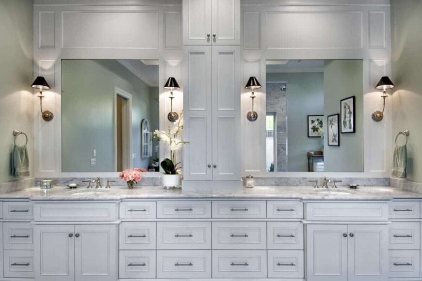 Primary bathroom showcasing a grand white vanity with double sinks and mirror accents.