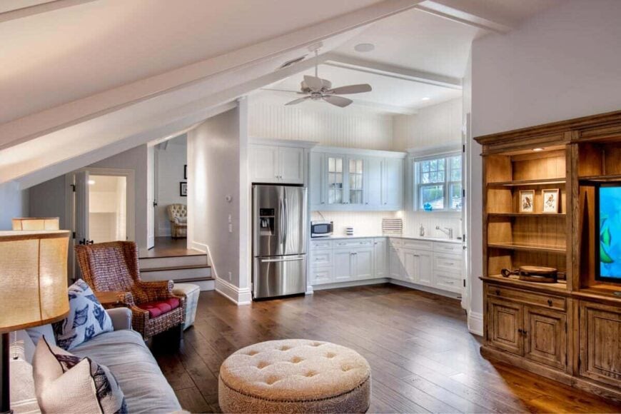 Bonus room with kitchenette and assorted seating under a sloped ceiling.