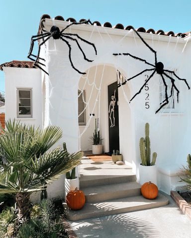 White house with DIY spiders and web