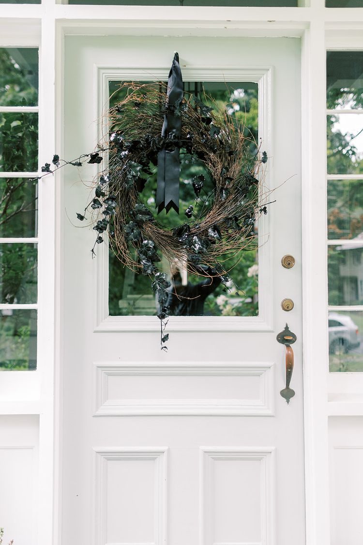 Black ivy wreath on front door