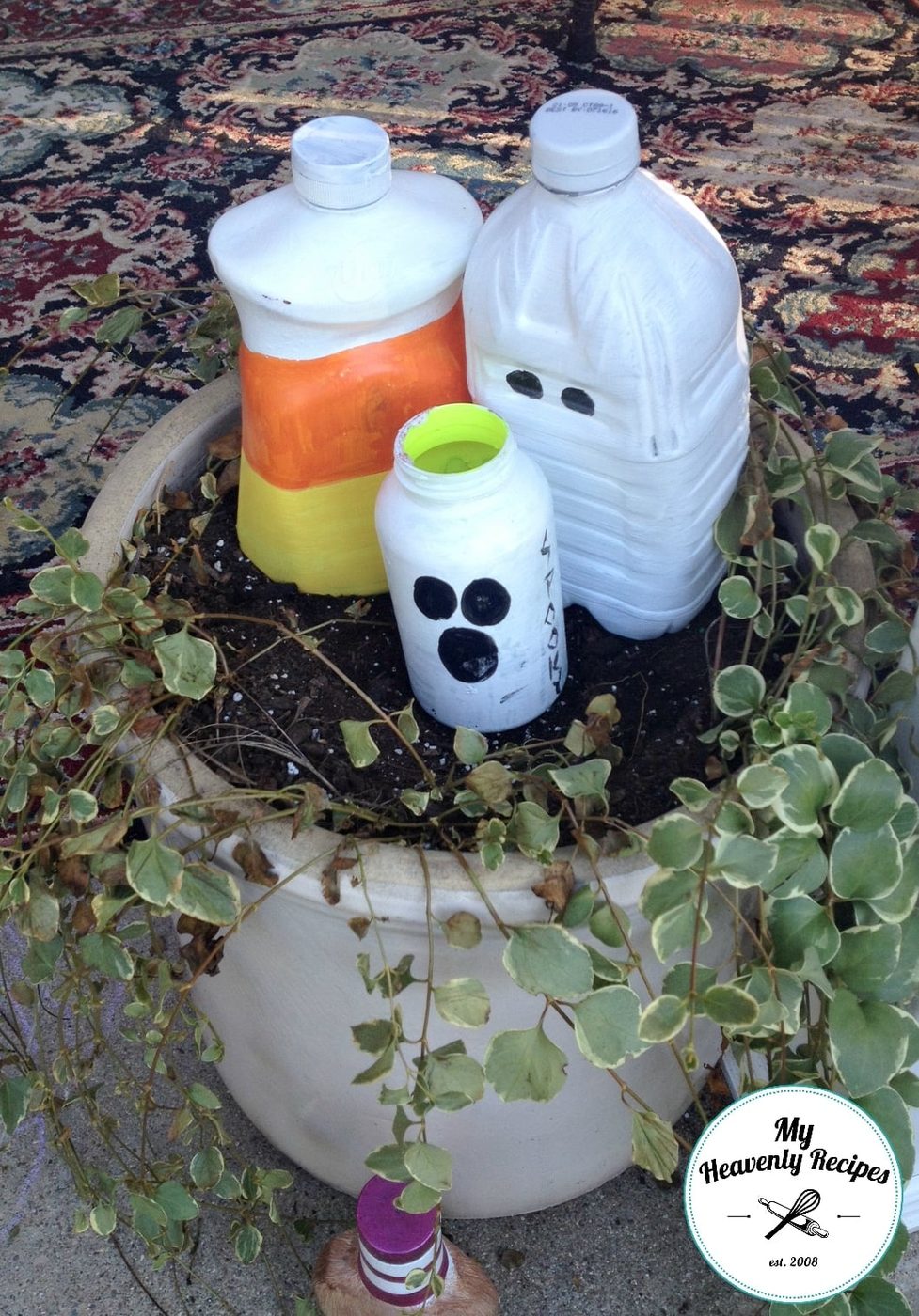 Jugs painted as Frankenstein and used to decorate backyard