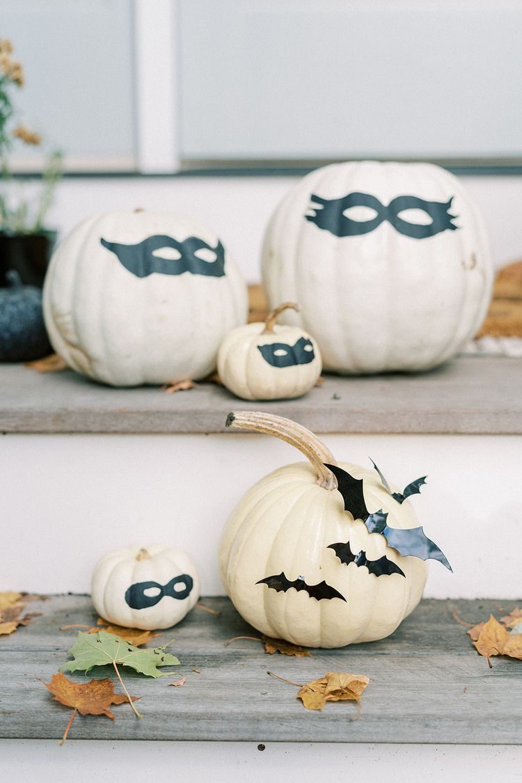 Painted white pumpkins on front porch steps
