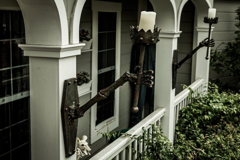 Small skeleton hanging off an outdoor lantern