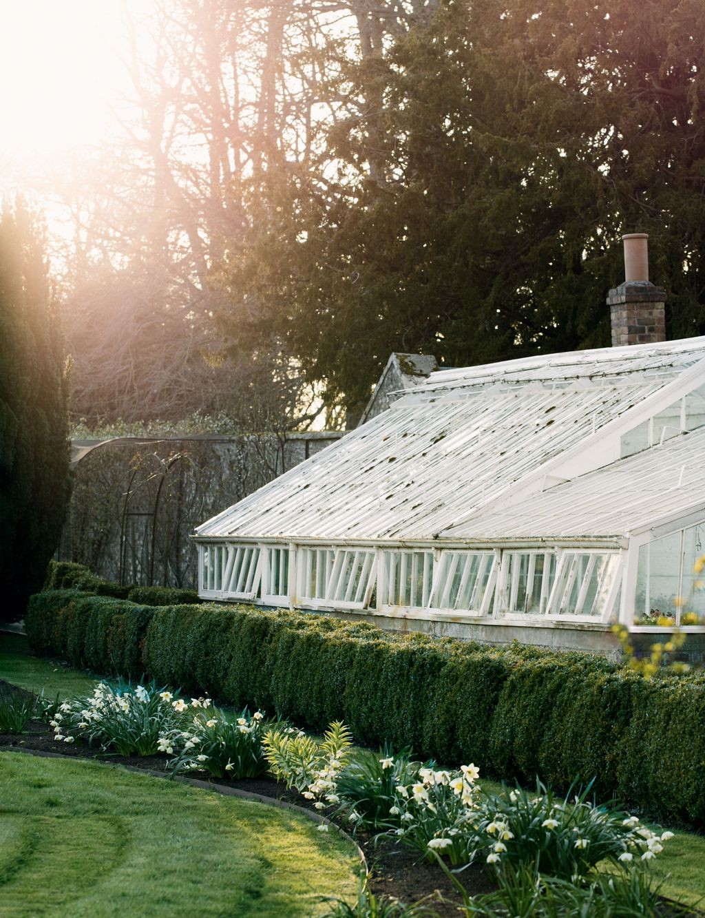 Restored Victorian glasshouse in an English garden