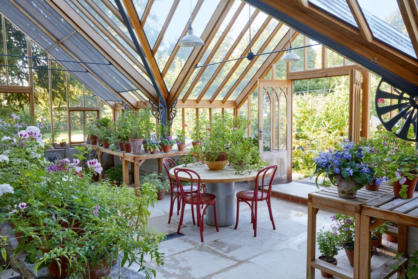 Greenhouse with a table and seating among plants