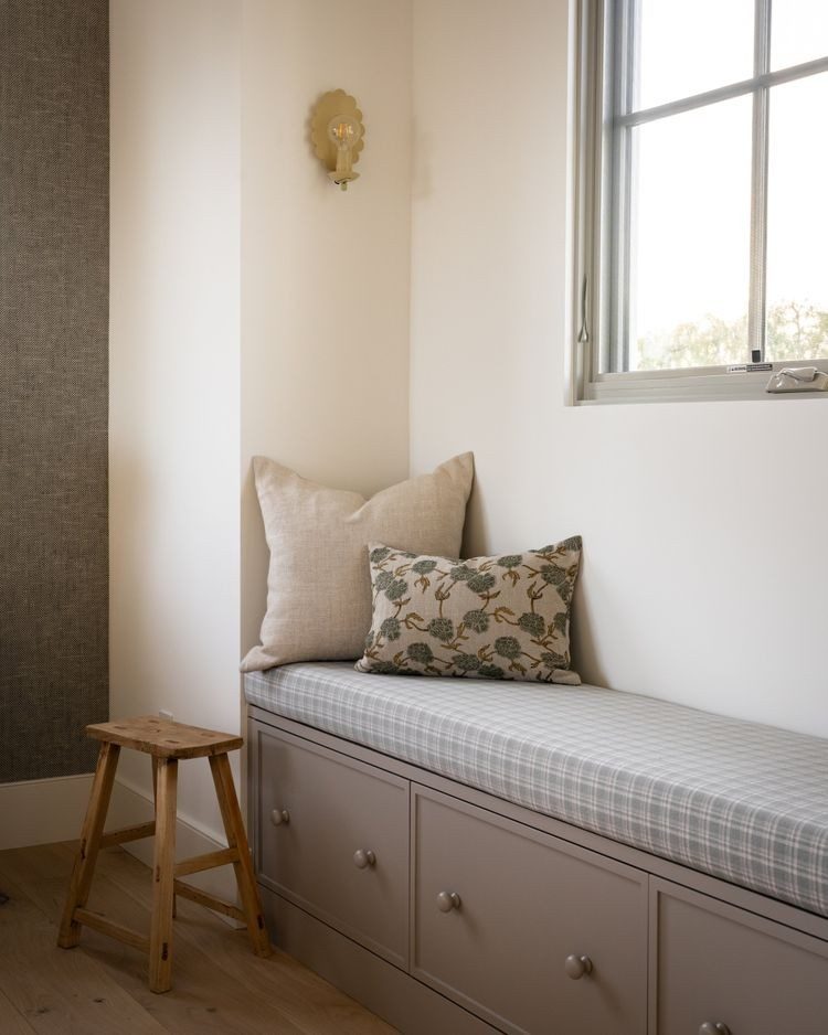 Built-in upholstered mudroom bench with deep storage drawers underneath
