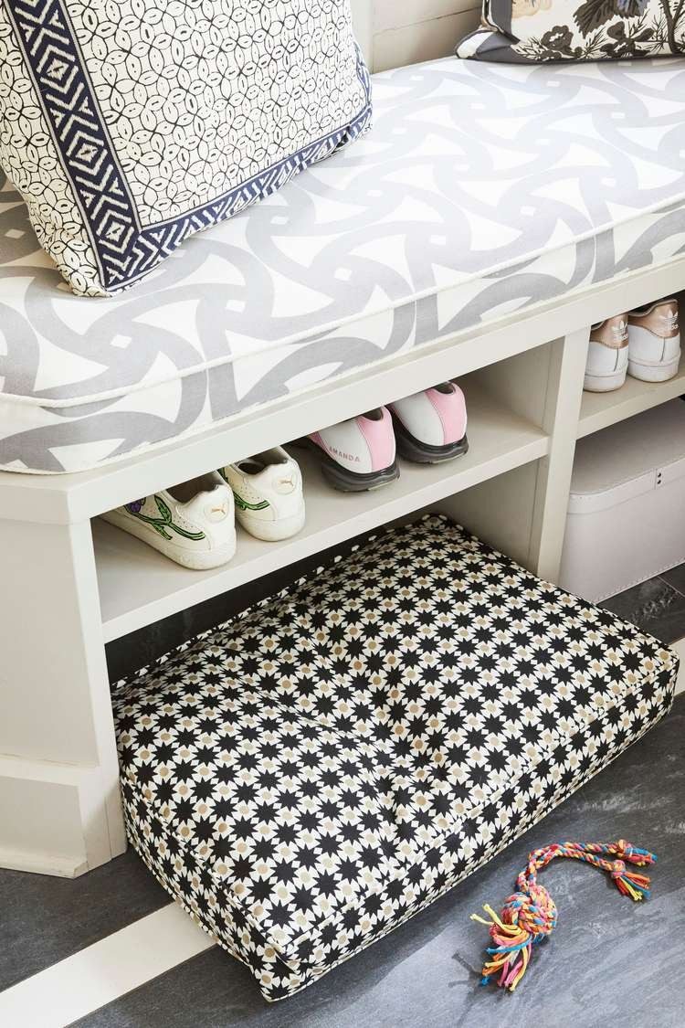Mudroom bench with lift-up cushioned seat over storage cubbies
