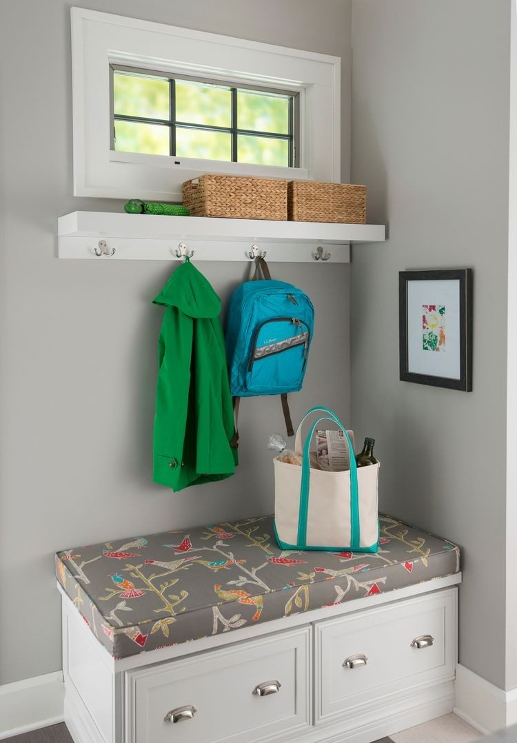 Tiny mudroom corner with a bench, shelf and hooks under a window